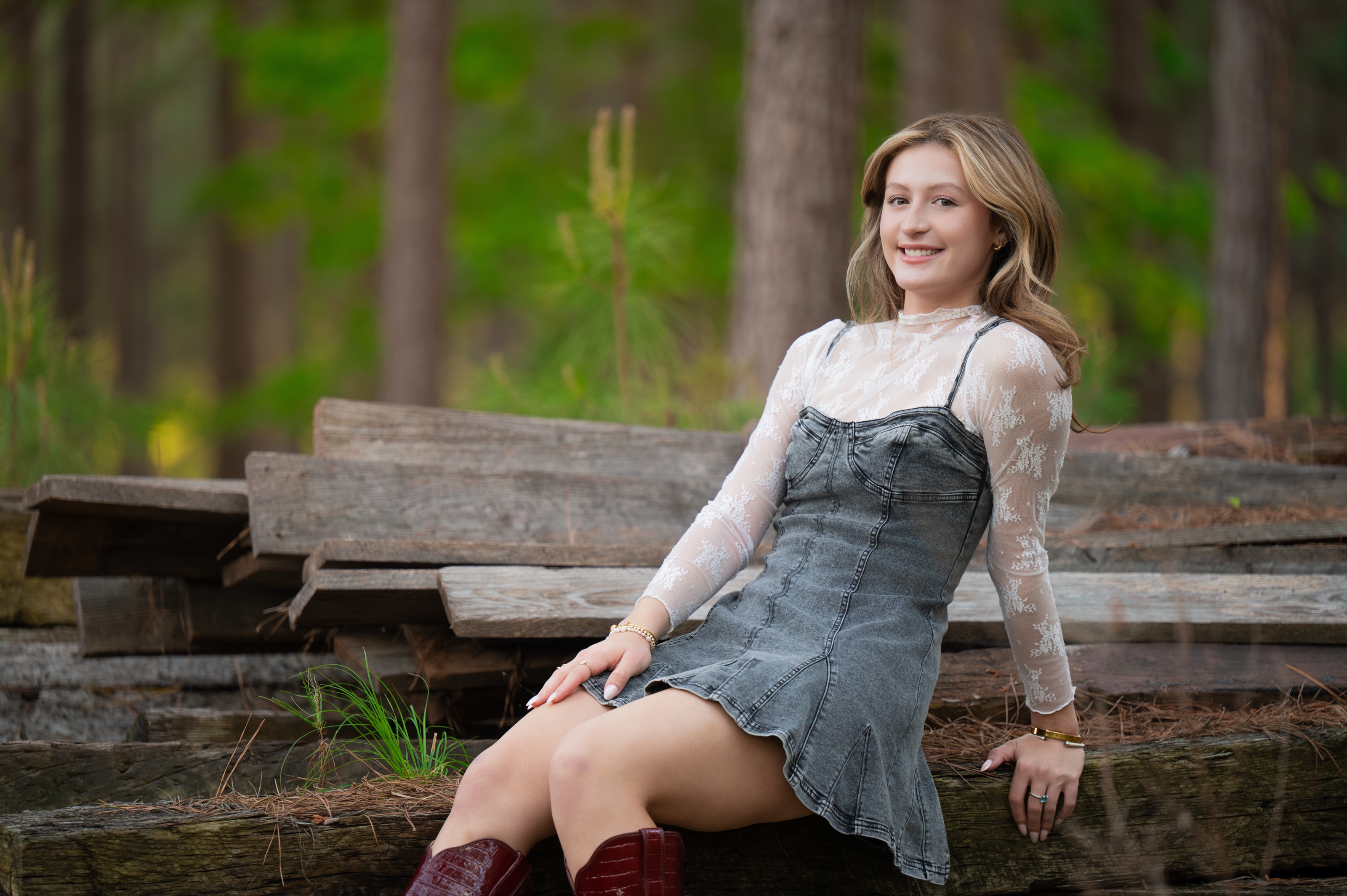 A high school senior photographed outdoors in warm light