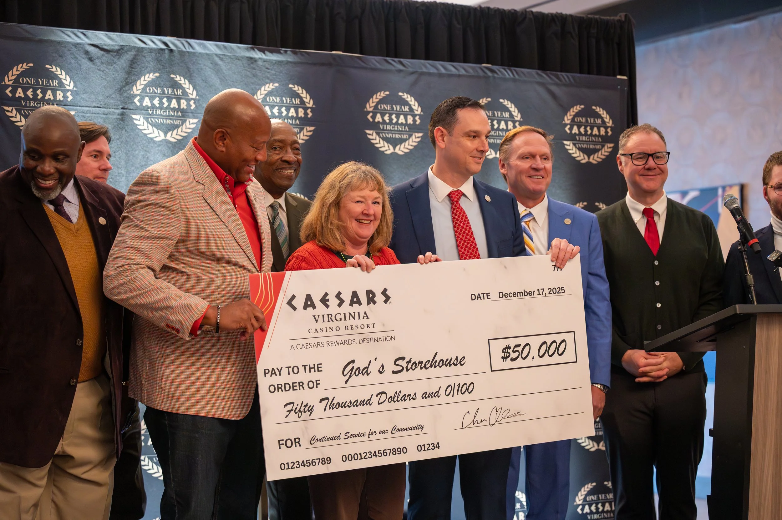 Community and business leaders presenting a fifty-thousand-dollar donation check at Caesars Virginia's one-year anniversary event in Danville