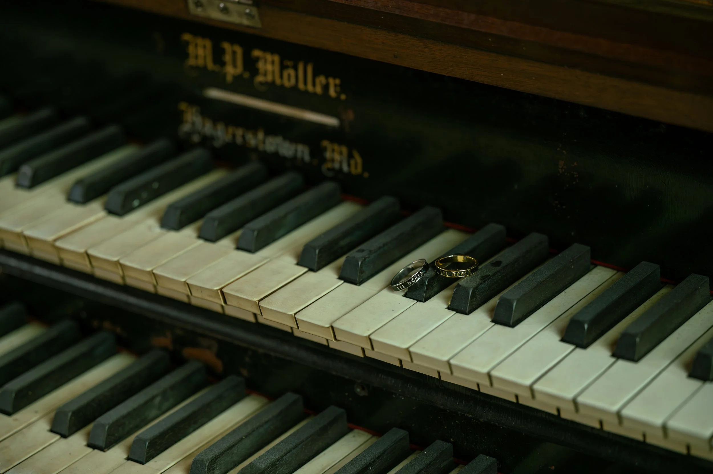 The wedding rings resting on the keys of an antique pipe organ
